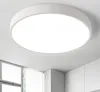 A white, round LED ceiling light is mounted on a white ceiling. Produktbild-Vorschau
