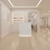 A modern salon reception area with a white reception desk and shelves displaying products. Produktbild-Vorschau