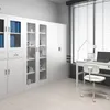 A modern office or storage room with white metal cabinets, a desk, and a chair. Podgląd zdjęcia produktu