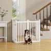 A dog sits in front of a white wooden pet gate in a home setting, with stairs visible in the background. Podgląd zdjęcia produktu