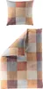 A pillowcase and a duvet cover are laid out on a white background, both featuring a patchwork design of squares in various warm colors. Produktbild-Vorschau