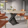 A dining table with an X-frame base and orange chairs in a modern dining room setting. Podgląd zdjęcia produktu