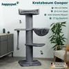 A grey cat tree with various platforms and toys, set in a room with furniture and a plant. Produktbild-Vorschau