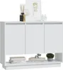 A white sideboard with three doors is shown against a white background. Decorative items like framed pictures, a diffuser, and a small clock are placed on top, while books and a small plant sit on the shelf below. Náhľad obrázku produktu