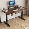 A home office setup with an adjustable standing desk, monitor, keyboard, and accessories. Anteprima dell’immagine prodotto