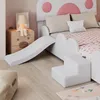 A child's bed with a slide and steps, set in a bedroom. Produktbild-Vorschau