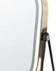 A close-up of the side of a makeup mirror, showing the gold frame and black stand. Náhled obrázku produktu