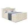 A beige upholstered boxspring bed with two pillows and a folded blanket, shown against a white background. Produktbild-Vorschau