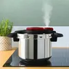 A pressure cooker on a stovetop with steam rising. Podgląd zdjęcia produktu