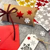 A collection of Christmas-themed crafting supplies, including a pillow box, stickers, and a gift tag, arranged on a grey felt surface. Produktbild-Vorschau