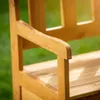 A close-up shot of a wooden garden bench armrest and seat. Náhled obrázku produktu
