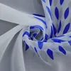 A close-up, swirled view of white sheer fabric with a blue leaf-like pattern. Produktbild-Vorschau