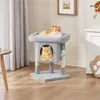 Two cats are resting on a multi-level cat tree in a living room setting. Podgląd zdjęcia produktu