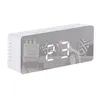 A white digital alarm clock with a mirrored LED display showing the time and temperature, placed on a white surface. Podgląd zdjęcia produktu