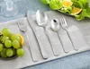 A set of cutlery is laid out on a light gray placemat, with grapes and orange slices on the left and a salad on the right. Anteprima dell’immagine prodotto