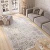 A modern living room with a sofa, rug, and ottoman. Náhled obrázku produktu