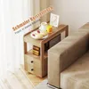 A narrow side table with breakfast items and a picture frame on top, placed next to a sofa. Produktbild-Vorschau