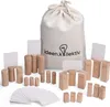 A collection of wooden figures and cards, along with a drawstring bag, are arranged on a white background. The figures are of various sizes and shapes, some resembling stylized people with carved features. The bag has a logo and text printed on it. Several Voir les images du produit