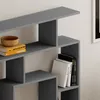 A close-up view of a modern, gray bookshelf with books and a wooden bowl on it. Anteprima dell’immagine prodotto
