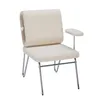A beige upholstered chair with silver metal legs and a small plush ball attached to the backrest. Anteprima dell’immagine prodotto