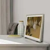 A Samsung The Frame TV displaying a painting of ballerinas is placed on a white table next to a decorative vase and a coaster. Produktbild-Vorschau