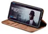 A smartphone in a brown flip case is displayed, showing a movie poster on its screen. Produktbild-Vorschau