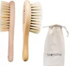 Two baby brushes and a drawstring bag are displayed against a white background. Produktbild-Vorschau