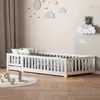 A child's bedroom with a white wooden bed, decorated with cloud-themed wall art. Anteprima dell’immagine prodotto