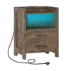 A brown wooden nightstand with two drawers and an open shelf illuminated by blue LED lights, with a black power cord extending from the side. Produktbild-Vorschau