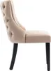Side view of a beige upholstered dining chair with tufted back and dark wooden legs. Produktbild-Vorschau
