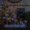 Christmas decorations including a tree, garland, and illuminated reindeer and sleigh figures. Produktbild-Vorschau
