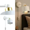 A collage of images showing a white and gold wall lamp with a plug and switch, and a close-up detail of the lamp's adjustable joint. Náhled obrázku produktu