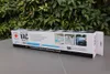 A product box for a spa vacuum set is displayed outdoors with greenery in the background. Produktbild-Vorschau