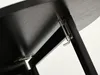A close-up view of the underside of a black table, showing the hinge mechanism and support structure. Náhľad obrázku produktu