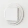 A white digital thermostat mounted on a white circular plate on a textured white wall. Anteprima dell’immagine prodotto