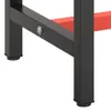 A close-up view of the black metal legs and red support beams of a workbench frame. Náhled obrázku produktu
