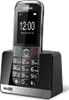 A black Maxcom MM720 senior phone is shown in its charging dock against a white background. Náhľad obrázku produktu