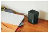 A black GoPro dual battery charger sits on a wooden surface next to a stack of books. Anteprima dell’immagine prodotto