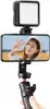 A person is holding a smartphone mounted on a tripod with a light attached. Produktbild-Vorschau