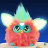 A brightly colored, fluffy toy with large eyes and glowing ears against a dark blue background. Anteprima dell’immagine prodotto