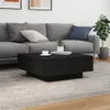 A black coffee table is placed in front of a gray sofa in a living room setting. Anteprima dell’immagine prodotto