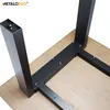 The underside of a table with black metal legs attached to a wooden tabletop. Produktbild-Vorschau