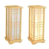 Two wooden floor lamps with parchment-like shades are shown against a white background. Náhled obrázku produktu