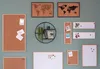 A collection of cork boards and whiteboards of various sizes and orientations are displayed on a green wall, some with photos and notes pinned to them. Produktbild-Vorschau