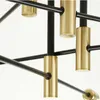 A close-up view of a modern chandelier with black metal rods and gold cylindrical accents. Produktbild-Vorschau