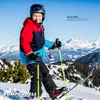 A young boy is skiing on a snowy mountain with ski poles and skis. Produktbild-Vorschau
