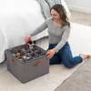 A woman is organizing shoes in a fabric storage bin next to a bed. Náhled obrázku produktu