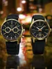 Two Seiko watches with black dials and gold accents are displayed against a blurred, colorful background. Náhled obrázku produktu