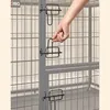 A hand is shown operating a latch on a metal pet crate. Náhľad obrázku produktu