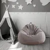 A bean bag chair and a teepee tent in a child's room decorated with stars and clouds. Produktbild-Vorschau